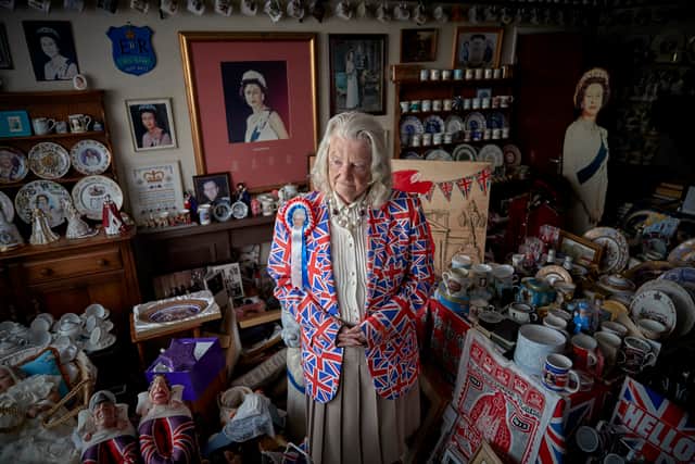 Margaret Tyler, 78, superfan of Queen Elizabeth II who has branded herself as Britain’s ‘most loyalist Royalist’, stands in her dinning room reflecting on the death of Queen Elizabeth II on September 10, 2022 in Wembley, England.