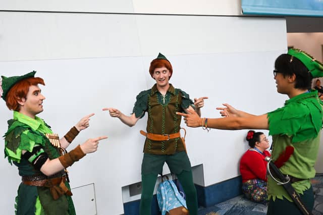 Fans cosplay in Peter Pan costumes during the Walt Disney D23 Expo in Anaheim, California on September 9, 2022
