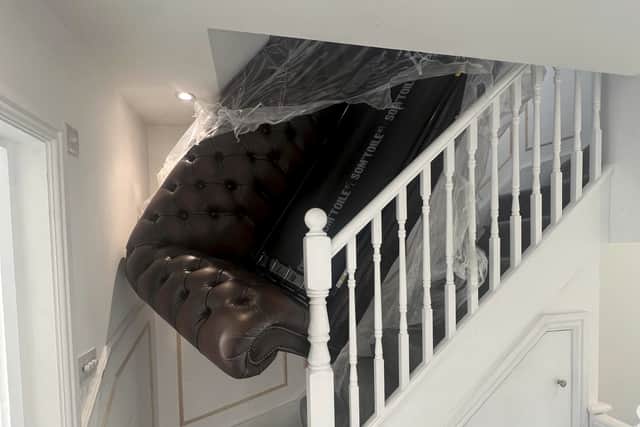 The sofa stuck on the stairs. See SWNS story SWLNsofa. A homeowner has slammed a furniture company after they abandoned a failed attempt to deliver new sofa - leaving it jammed on the stairs. Luke Ansell, 27, had just moved in to his brand new £500k home in Bournemouth in December when he bought an over £2,000 sofa that was delivered on January 19. Despite delivery-men assuring him that they made tight deliveries 'all the time' - the pair from designersofasforyou.co.uk failed to get the new sofa-bed up a narrow staircase, before abandoning it. Photos of the shocking attempted delivery show how the pair left huge holes in the staircase plasterwork, and damage to the woodwork, before leaving.