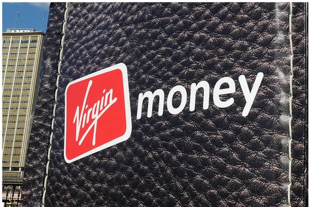 British entrepreneur Richard Branson walks out of a giant wallet as he launches Virgin Money's new credit cards in Sydney Harbour on July 27, 2010. The financial services arm of Branson's Virgin Group now offers Australians low interest rate credit cards, savings accounts, superannuation and car insurance. AFP PHOTO / Torsten BLACKWOOD (Photo by TORSTEN BLACKWOOD / AFP) (Photo by TORSTEN BLACKWOOD/AFP via Getty Images)