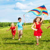 Children flying a kite (photo: adobe)