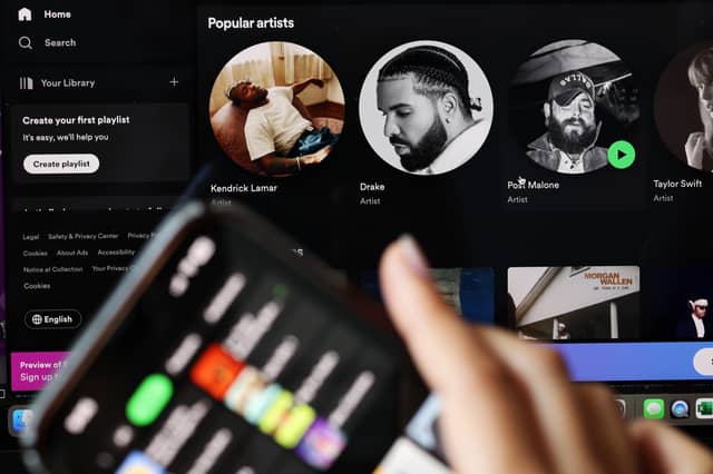 In this photo illustration, the Spotify music app is seen on a phone. Photo by Michael M. Santiago/Getty Images