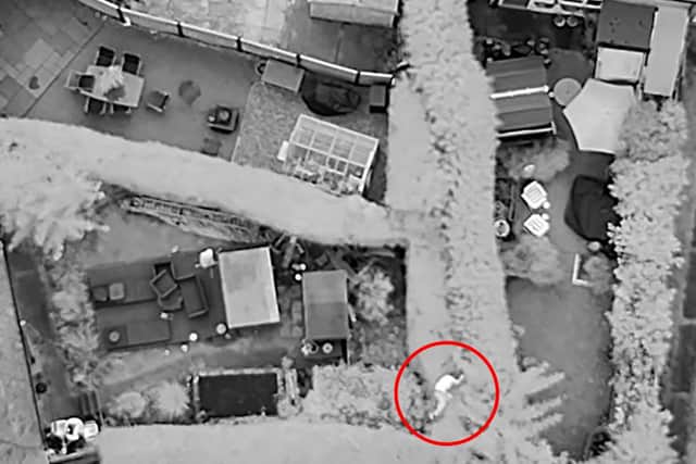 Man climbs over fences before he's found in bush by police dog.