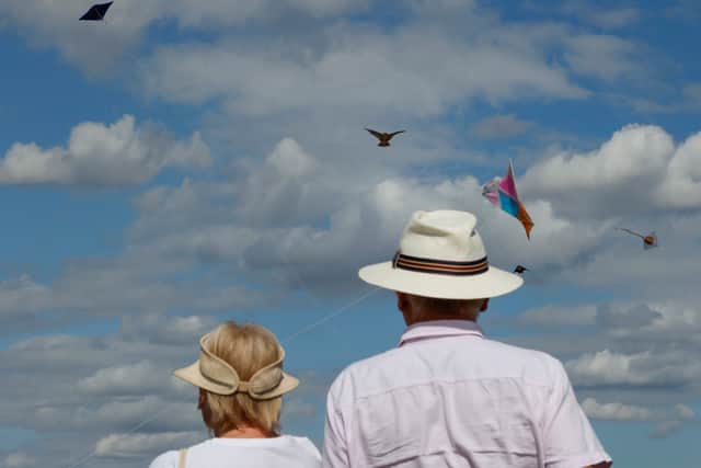 An elderly couple watches as members of the Afghan community and Londoners fly kites on Hampstead Heath. UK pensioners are set for a likely 4.8% state pension rise from April 2026 (Photo: CARLOS JASSO/AFP via Getty Images)