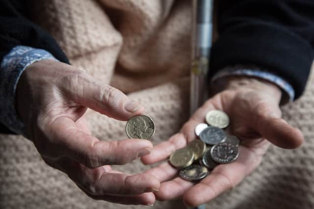 An elderly person looks at cash at home. Winter Fuel Payments for 2025/26 will start arriving in November, with most paid by December (Photo: Matt Cardy/Getty Images)