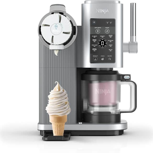 The Ninja Creami Scoop and Swirl shown mid-serve, dispensing soft vanilla ice cream straight into a cone.