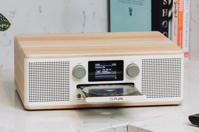 The Pure Classic C-D6 features twin stereo speakers, a central colour display and a front-loading CD player in a retro-inspired white and oak design.