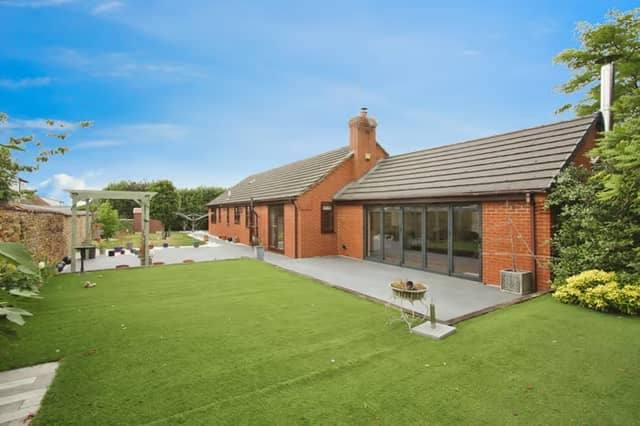 A smart, well-kept bungalow set back in a quiet village cul-de-sac, with a driveway that hints at the space beyond