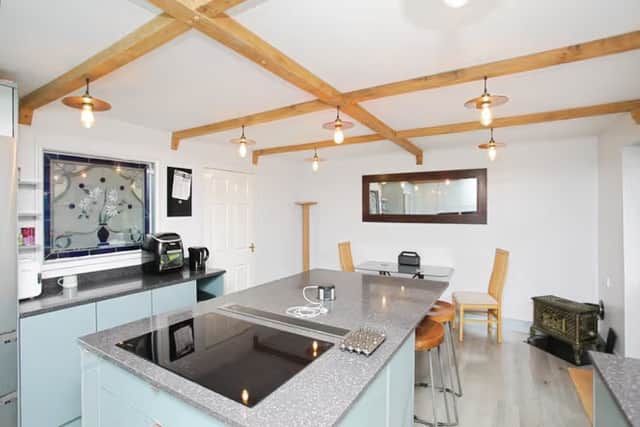 A bright, practical kitchen with central island and garden views, designed for both everyday living and hosting