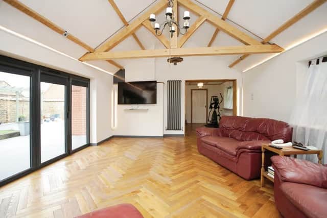 The extended lounge blends character and light beautifully, with beams overhead and doors opening out to the garden
