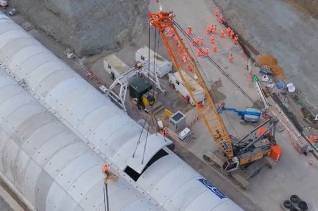 The last of 5,020 reinforced concrete segments for a HS2 green tunnel is lifted into position at the site near Chipping Warden in Northamptonshire.