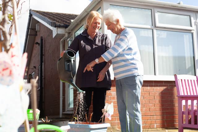 Homelium carer helping in the garden
