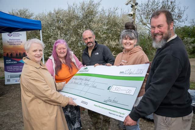 Kate from Barratt Homes handing the cheque to Veterans Community Network
