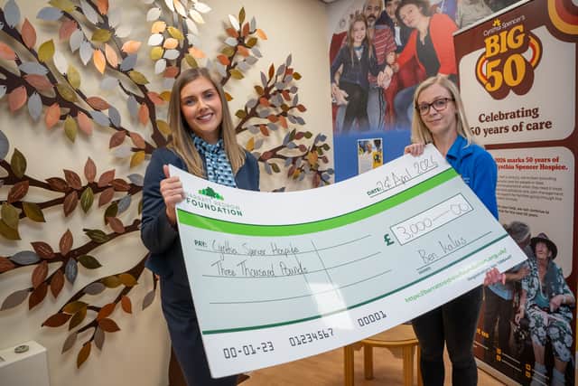 Chloe handing the cheque to Nina from Cynthia Spencer Hospice