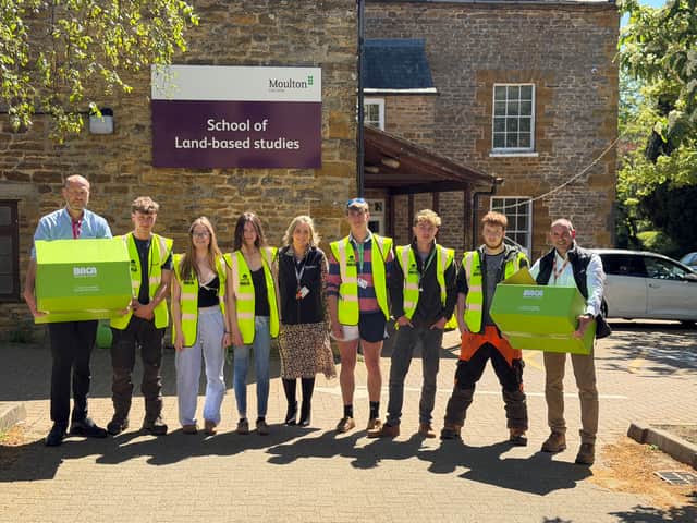 Pictured are Moulton College students wearing the high-visibility vests, alongside Polly Greco (centre) Patrick Spooner (far left) and Kev Garfield (far right)