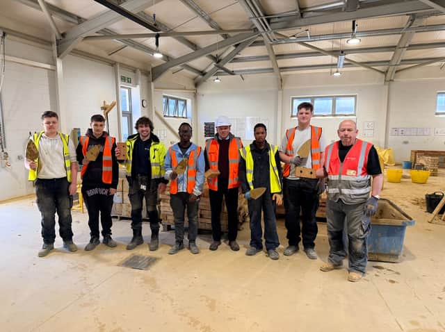 Darren Knox, Contracts Manager at Persimmon Homes Midlands; Joshua Cass, Technician Demonstrator, Northampton College with various students.
