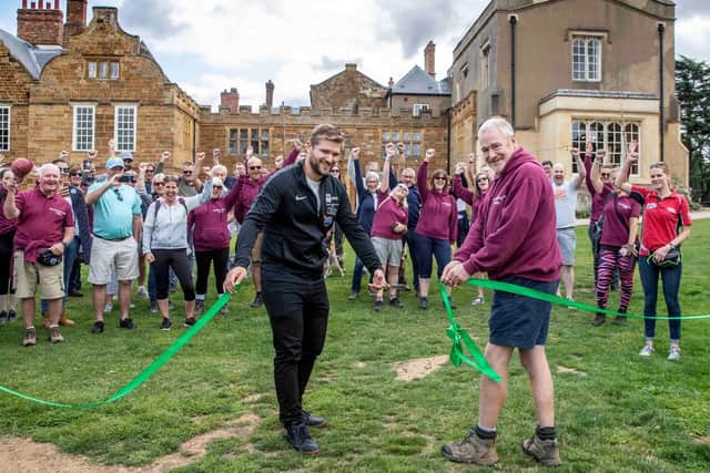 Associate Professor Dr Declan Ryan (left) cutting a ribbon at an event at Delapre Abbey.