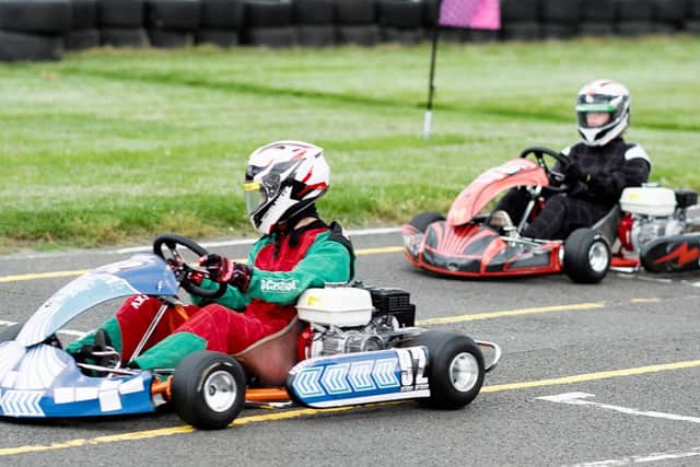 Two Montsaye karts enjoying some friendly racing action down the finish straight.

