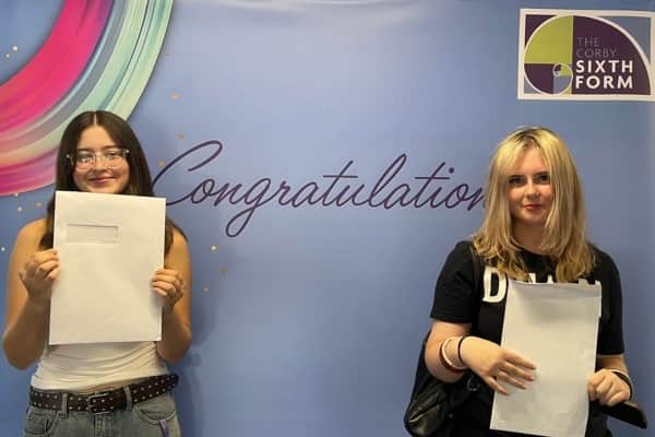 Jessica (left) shares the excitement of A Level Results Day with a friend at The Corby Sixth Form.