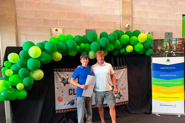 Emilio Politano celebrating with Mr Wears at Corby Business Academy as he collects his GCSE results.