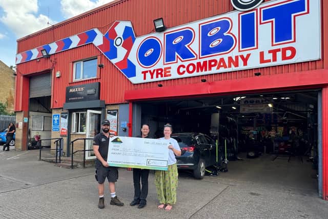 Cheque presentation at Orbit tyres in Rushden
