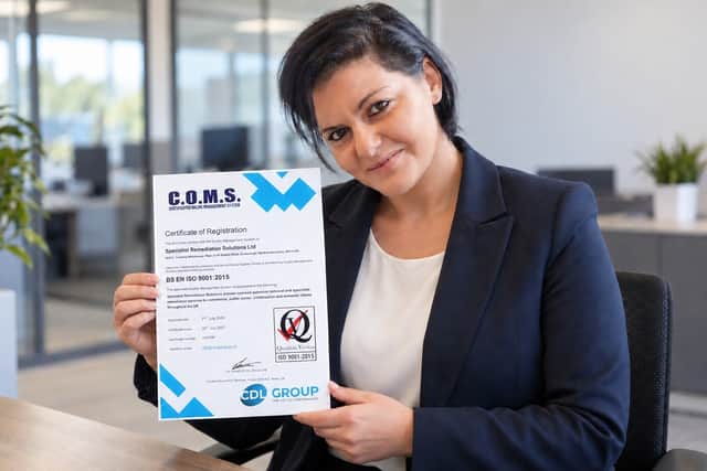 Elena Paunete with the ISO 9001 certificate
