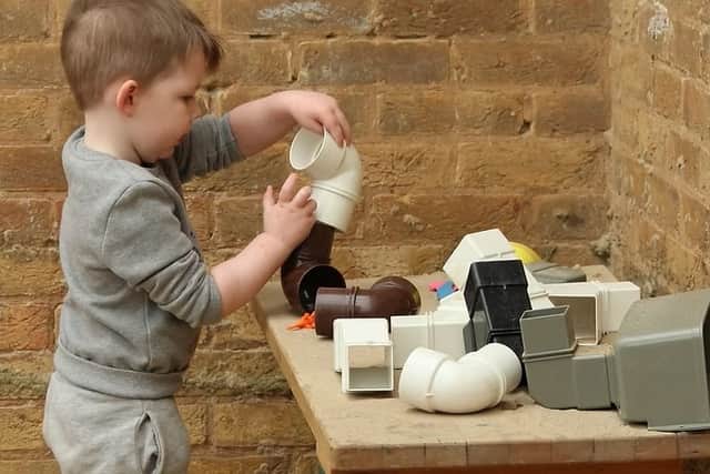 A child deep in concentration as he explores the pipe connectors at Camrose.