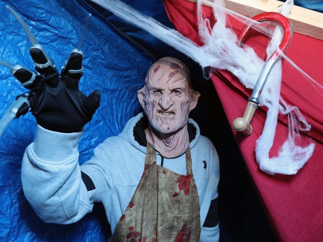 This terrifying man appeared from around a curtain