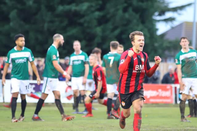 Ben Milnes heads off to celebrate after scoring a fine free-kick