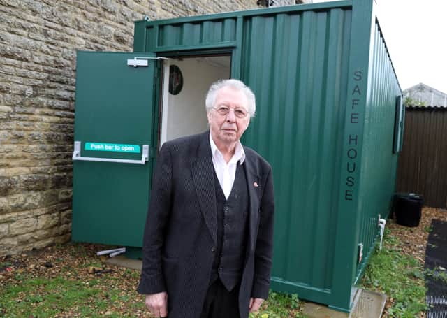 Businessman Tom Butler with the safe room he is marketing for industrial and domestic use.