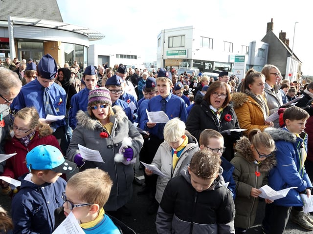 The crowd join in the service