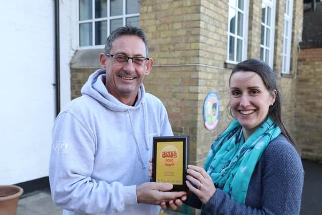Ed Reeves presents the plaque to Helen Roberts