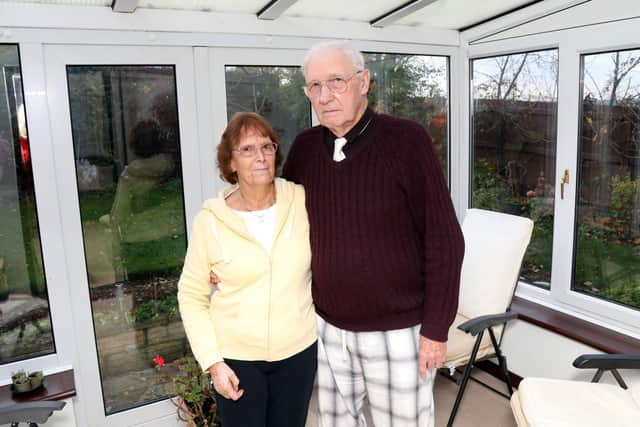 Jill and Mike Ashwell in their conservatory that is now too 'noisy' to use