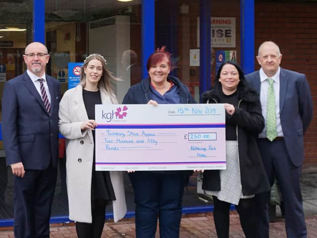 Kettering Park Hotel employees Andrew Hollett, Rosie Law, Victoria Charlesworth, and Ian Lewis present a cheque for 250 to midwife Nicola Perry on November 15.