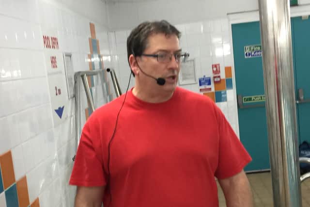 Coach Howard Farrow talking to swimmers via the Myjukes headsets