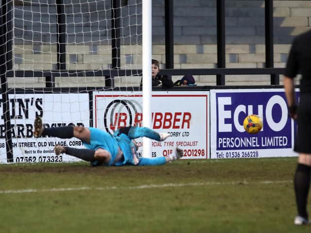 Thame United goalkeeper Craig Hill saves Jordon Crawford's penalty during the first half of Corby Town's 2-0 defeat at Steel Park. Pictures by Alison Bagley