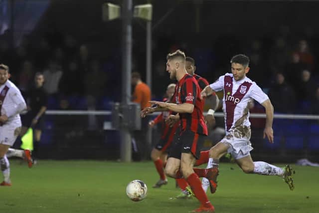 Connor Kennedy drives forward during another man-of-the-match display for the Poppies