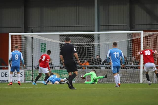 Tunde Owolabi opens the scoring for FC United during the Poppies' 2-1 defeat