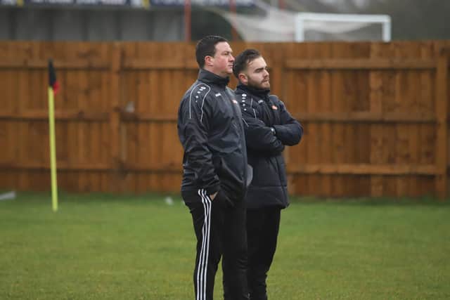Manager Paul Cox and coach Ben Marvin watch on as they put the Poppies players through a training session on Boxing Day