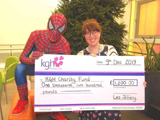 Regular KGH fundraiser Spiderman  aka Leslie Jeffery  pictured with KGH fundraising assistant Maxine Andrews and a cheque for 1,200 raised through fundraising collections and a 40-mile bike ride
