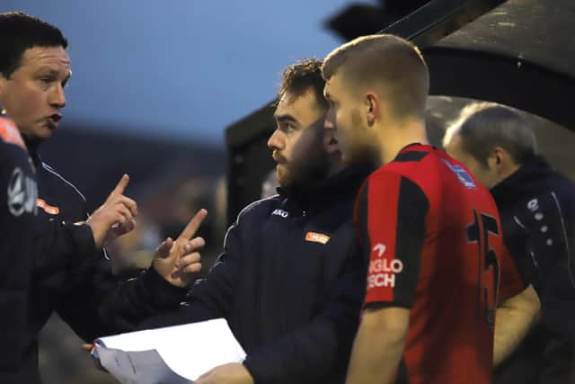 Paul Cox gives Jason Law some final instructions before he came off the bench to hit the winner for Kettering
