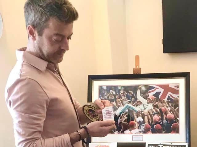 Joe Byrne, manager of The Blue Bell Inn, Gretton draws the winning ticket for the signed photograph of Lewis Hamilton