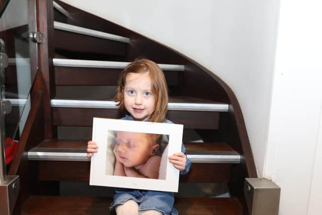 Polly Carlton with a photo of herself as a baby