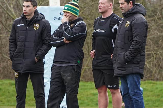 Vass (right) watches on