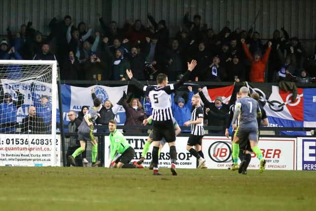 The Halesowen fans celebrate after Jordan Piggott gave them the lead at Steel Park