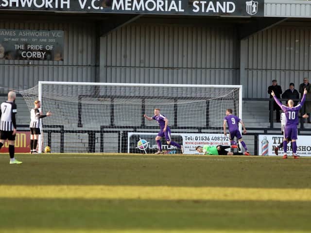 Adam Creaney scores Daventry Town's goal which gave them the lead before Corby Town hit back to earn a 1-1 draw at Steel Park. Pictures by Alison Bagley