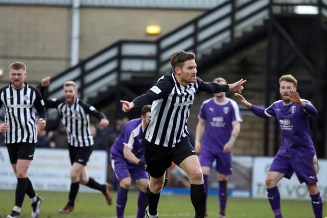 Elliot Sandy heads off to celebrate after he scored the Steelmen's equaliser