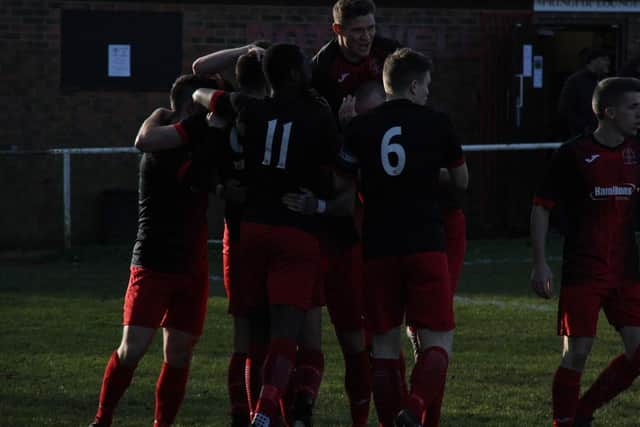 Andy White is mobbed by his Corinthians team-mates after he opened the scoring