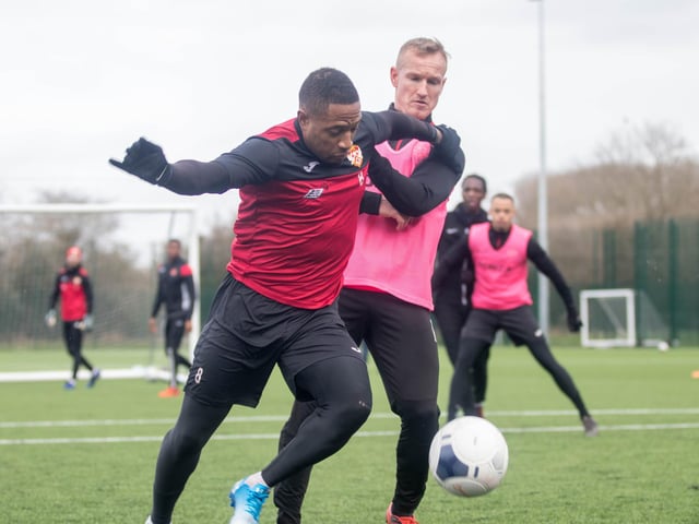 Aaron O'Connor holds off Brett Solkhon during training