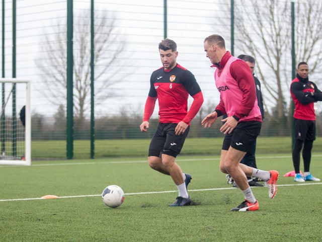 Michael Richens and Brett Solkhon challenge for the ball